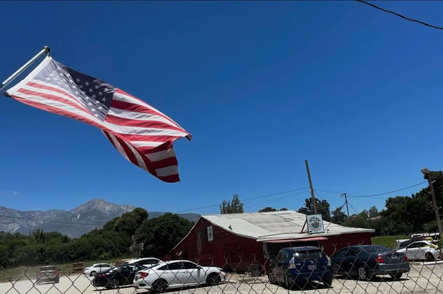 American flag flying over the historic Nicolson Strawberries farm and roadside stand in Rancho Cucamonga